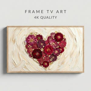 May include: A framed artwork featuring a heart-shaped floral arrangement. The heart is composed of deep red flowers and gold accents, set against a textured cream-colored background. The frame is light wood. Text at the top reads "FRAME TV ART" and "4K QUALITY".