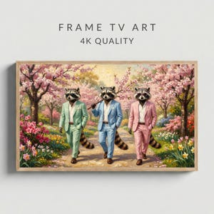May include: A framed digital art print featuring three raccoons in suits walking on a path. The raccoons wear green, blue, and pink suits. The background shows a garden with pink flowering trees and the text "FRAME TV ART 4K QUALITY".