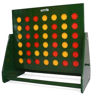 May include: A large wooden Connect Four game with a dark green frame and a grid of holes. The game board features alternating rows of red and yellow game pieces. The text "Big Game Hunters" is visible on the top left.