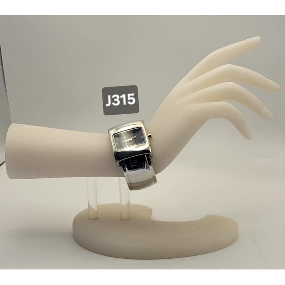 silver-tone rectangular cuff watch with a black d… - image 1