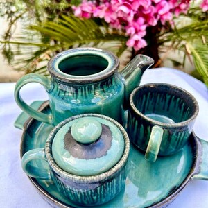 Top view handmade teal ceramic tea set teapot cups tray Khurja pottery unique glaze