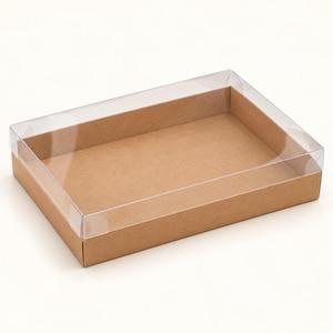 May include: A rectangular box with a brown cardboard base and a clear, transparent plastic lid. The container features low, sturdy sides and a flat bottom, providing an open view of the interior space through the top cover.