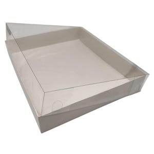 May include: A clear plastic lid covers a white cardboard box. The box is rectangular with a slightly angled top. The lid is transparent, allowing a view of the box's interior. The box is designed for packaging.