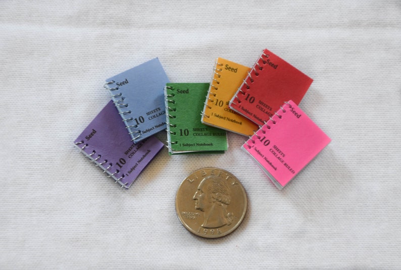 May include: Six small, colorful spiral bound notebooks with the word "Seed" and "10 Sheets Collage" printed on the covers.