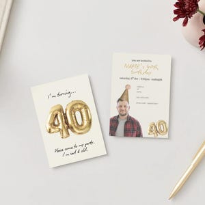 May include: Two birthday cards on a white surface. One card says "I'm turning... 40" with a gold balloon design. The other card says "NAME's 40th Birthday" with a photo of a man wearing a party hat. A gold pen and flowers are also present.
