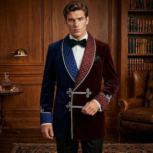 May include: A two-tone velvet jacket, split vertically with navy blue and burgundy. The jacket features a quilted lapel, silver trim, and decorative closures. A green bow tie and pocket square complete the formal look. The jacket is a stylish piece of apparel.