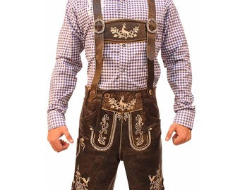 May include: Brown leather lederhosen shorts with suspenders, featuring white embroidered deer and floral designs. The suspenders have metal buckles. The outfit is paired with a blue and white checkered shirt.