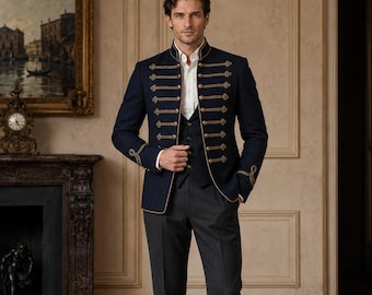 May include: A dark navy blue military-style jacket featuring gold braided cord detailing across the front and cuffs, worn over a white button-down shirt, a dark vest, and charcoal gray trousers. The jacket has a high collar and structured fit.