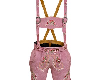 May include: Pink leather lederhosen shorts with suspenders. The shorts feature floral embroidery on the front, sides, and suspenders. The suspenders have metal buckles and are attached to the shorts with buttons.