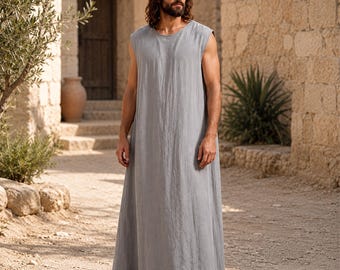 May include: A sleeveless, floor-length tunic in a solid light gray color. The garment features a simple round neckline and a loose, straight-cut silhouette that falls to the ankles. The fabric appears to have a textured, matte finish.