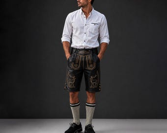 May include: A man wearing a white button-down shirt, black leather shorts with gold embroidery, gray socks with black stripes, and black shoes. The shorts feature deer designs.