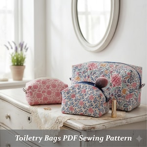 Może przedstawiać: Trzy kosmetyczki w kwiaty o różnych rozmiarach stoją na białej komodzie. Torby mają pikowany wzór z różowymi, niebieskimi i żółtymi kwiatami. Pędzel do makijażu i szminka są umieszczone na środkowej torbie. Tekst "Toiletry Bags PDF Sewing Pattern" znajduje się na dole.