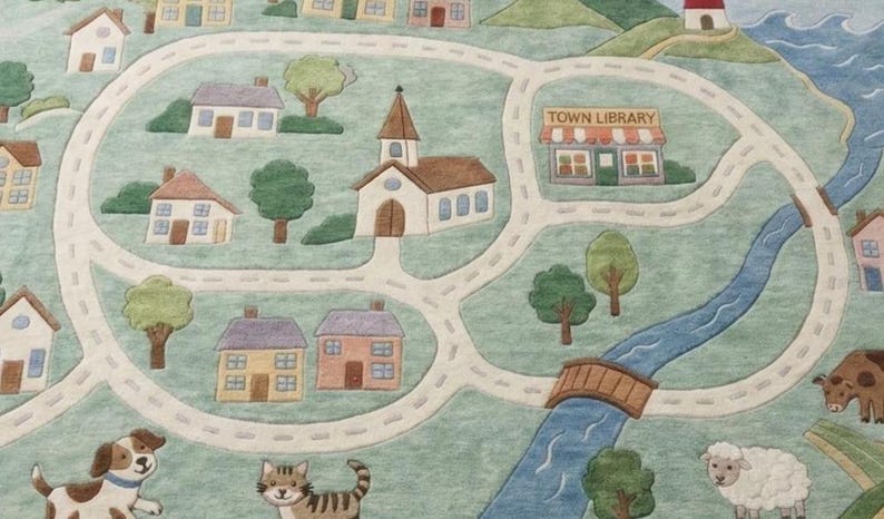 May include: A colorful rug depicting a town scene with roads, houses, a church, and a library. The rug features a river, a bridge, and illustrations of a dog, cat, sheep, and cow. The text "TOWN LIBRARY" is visible.