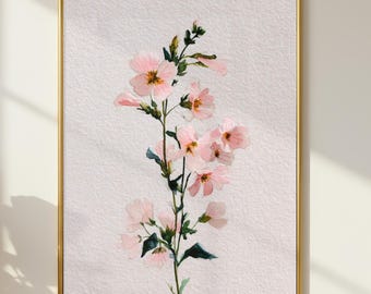 Könnte beinhalten: Ein gerahmter Aquarelldruck mit einem zarten Blumenstiel mit zartrosa Blüten und grünen Blättern. Das Kunstwerk ist vor einem strukturierten weißen Hintergrund platziert und in einem goldfarbenen Rahmen eingefasst. Der Druck wird an einer weißen Wand gezeigt.