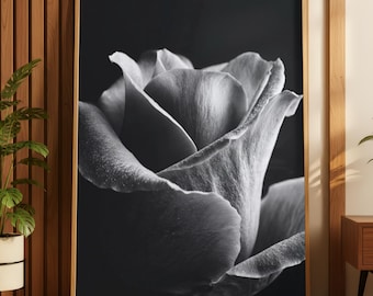 Könnte beinhalten: Schwarz-Weiß-Fotografie einer Rose in voller Blüte. Die detaillierten Blütenblätter haben eine weiche, samtige Textur. Das Bild ist in einem Holzrahmen gerahmt, was eine klassische und elegante Ästhetik schafft. Das Kunstwerk wird in einem Raum mit Holzverkleidung ausgestellt.