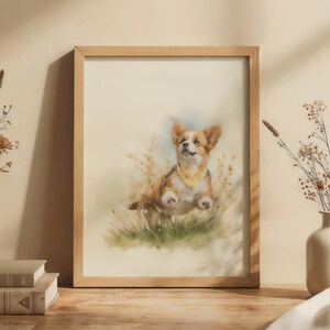 May include: A framed watercolour print of a corgi dog in a field of tall grass. The artwork has a light brown wooden frame and is displayed on a rustic wooden table. Two small white vases with dried flowers flank the print, adding a touch of natural decor.