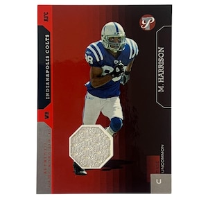 May include: A football trading card featuring M. Harrison of the Indianapolis Colts. The card has a red and black background with the team's logo and player information. An authentic game-worn jersey swatch is included.