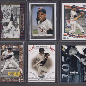May include: A collection of six baseball trading cards featuring Willie Mays. The cards showcase various action shots of Mays in his baseball uniform, with the Giants logo visible on some. The cards are encased in protective sleeves.