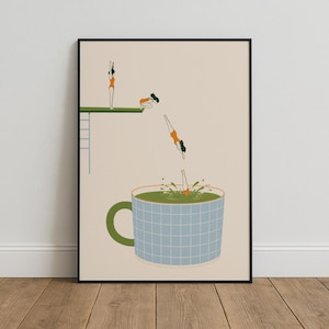 May include: A framed wall art print on a beige background featuring a green diving board with a ladder. Three figures in orange swimsuits are shown in various stages of diving into a large, light blue grid-patterned mug filled with green liquid.