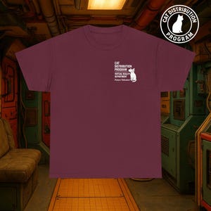 May include: A maroon t-shirt with white text and a cat graphic. The text reads "Cat Distribution Program, Virtual Reality Department, Future Volunteer." A circular logo with a cat silhouette is also visible.