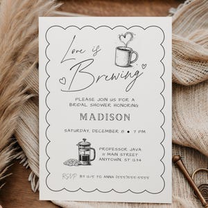 May include: Cream-colored bridal shower invitation with scalloped edges. The text "Love is Brewing" is written in elegant script, with a coffee cup illustration. Details include the honoree's name, date, time, and RSVP information.