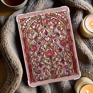 May include: A tablet case featuring a stained-glass design with pink, red, and gold accents. The artwork includes hearts, roses, and ornate scrollwork. The case has a light pink border and a clear protective cover.