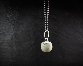Sterling silver and concrete sphere pendant.