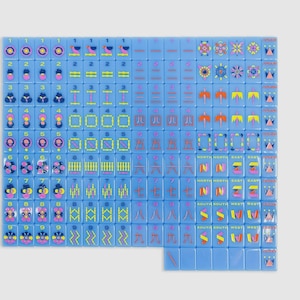 May include: A complete set of light blue mahjong tiles arranged in a grid. Each tile features colorful graphic illustrations, including numbers, Chinese characters, directional symbols, and floral patterns in shades of pink, yellow, and dark blue.