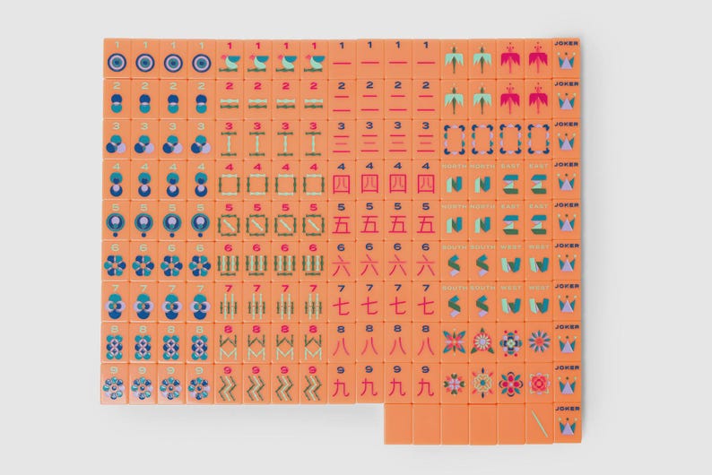 May include: A complete set of orange mahjong tiles arranged in a grid. The tiles feature various colorful illustrations, including numbers, Chinese characters, directional symbols, flowers, and joker tiles with crown icons, all on a solid orange background.