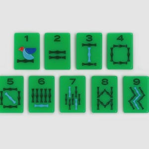 May include: A set of nine rectangular green Mahjong tiles arranged in two rows, numbered one through nine. Each tile features black and blue ink designs, with the number one tile displaying a small red, blue, and light blue bird graphic.