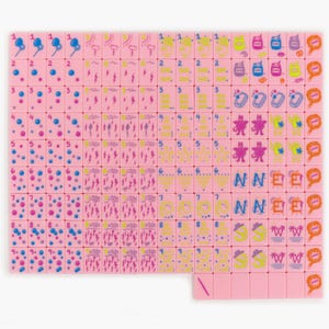 May include: A set of pink mahjong tiles arranged in a grid, featuring various colorful icons including numbers, weather symbols, and cartoon characters. Each tile displays a unique graphic design in blue, yellow, purple, and orange ink.