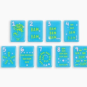 May include: A set of nine rectangular light blue tiles, each featuring a white number from one to nine and the word BAM in various lime green graphic arrangements, including a bird illustration, dots, stars, and exclamation points.
