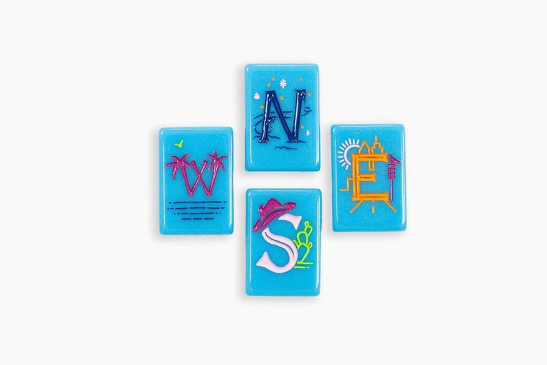 May include: Four rectangular light blue tiles arranged in a compass formation. Each tile features a letter: W with pink palm trees, N with dark blue waves and stars, E with an orange sun and city skyline, and S with a pink cowboy hat and cactus.