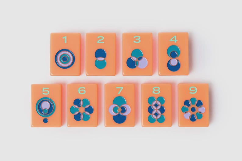 May include: A set of nine rectangular orange tiles, each featuring a unique geometric pattern of overlapping circles in shades of blue, teal, and lavender. Each tile is numbered from one to nine in a light green font, arranged in two rows.