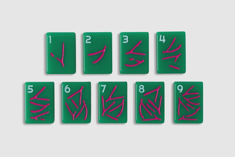 May include: A set of nine rectangular green tiles, each featuring a white numeral from one to nine in the top left corner and a corresponding number of pink wishbone-shaped symbols arranged in the center of each tile surface.
