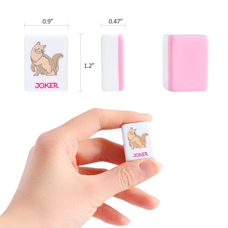 May include: A white and pink rectangular Mahjong tile featuring a brown cat illustration and the text JOKER in pink. The tile measures 0.9 inches wide, 1.2 inches high, and 0.47 inches deep, shown from front, side, and back perspectives.