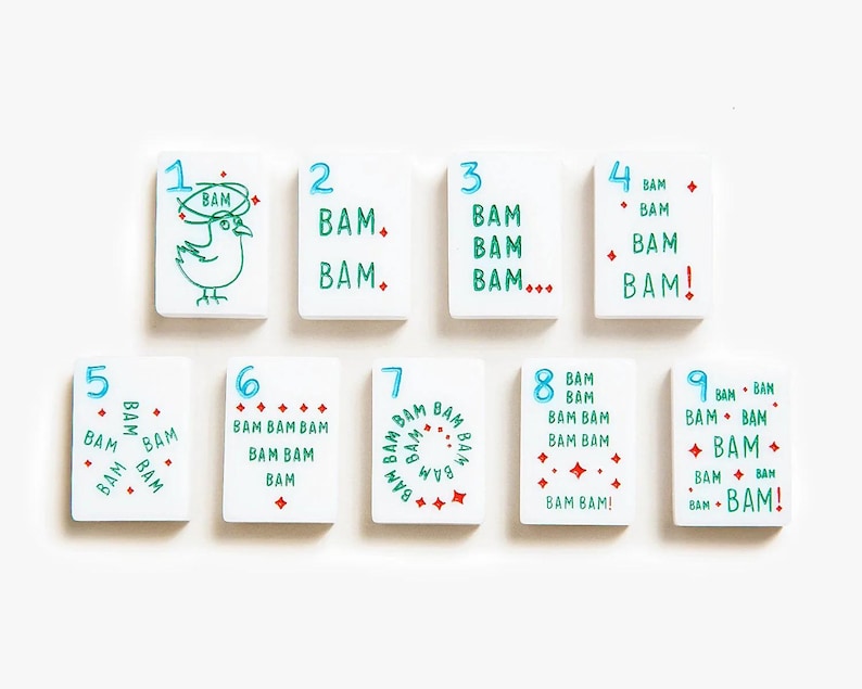 May include: A set of nine rectangular white tiles numbered one through nine in blue. Each tile features the word BAM in green text, repeated according to the number, with red accents including dots, diamonds, and a bird illustration on the one tile.
