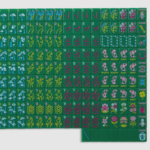 May include: A set of green Mahjong tiles arranged in a grid, featuring various colorful illustrations including mushrooms, plants, dragons, compass directions, and joker tiles with symbols like an elephant, eye, beetle, clover, and a small figure.