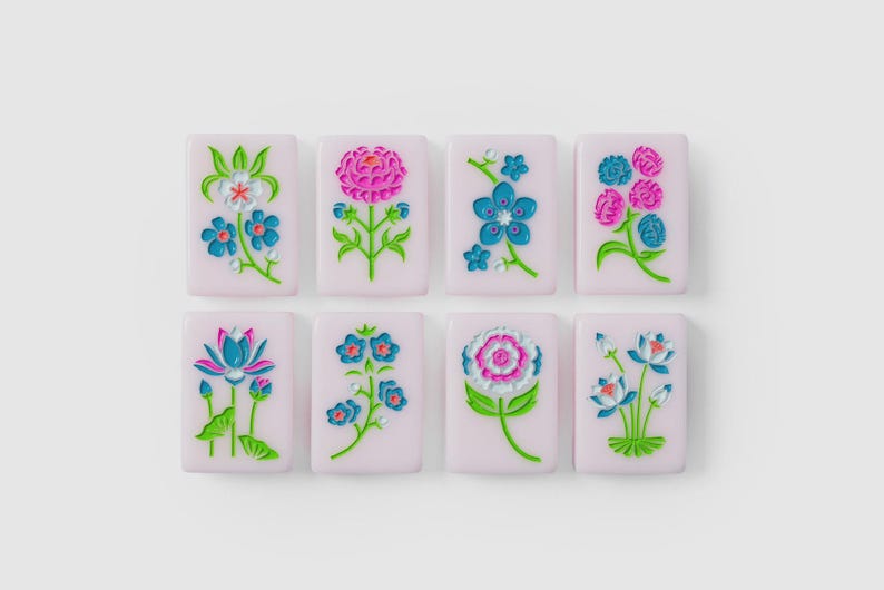 Puede incluir: Ocho baldosas rectangulares de color rosa claro dispuestas en dos filas, cada una con un dise&ntilde;o floral en relieve &uacute;nico en colores vibrantes como azul, rosa, verde y blanco. Las baldosas tienen un acabado liso y motivos bot&aacute;nicos.