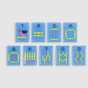 May include: Nine rectangular light blue tiles arranged in two rows, each featuring a dark blue numeral from one to nine at the top. The tiles display various geometric patterns in yellow and pink, including lines, shapes, and abstract symbols.