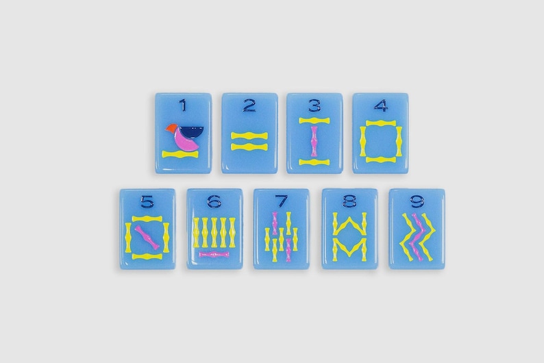 May include: Nine rectangular light blue tiles arranged in two rows, each featuring a dark blue numeral from one to nine at the top. The tiles display various geometric patterns in yellow and pink, including lines, shapes, and abstract symbols.