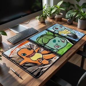 May include: A rectangular mousepad featuring three panels with cartoon images of Pokémon characters. The top panel shows Squirtle, the middle panel shows Bulbasaur, and the bottom panel shows Charmander. The mousepad is on a wooden desk with a keyboard and computer.