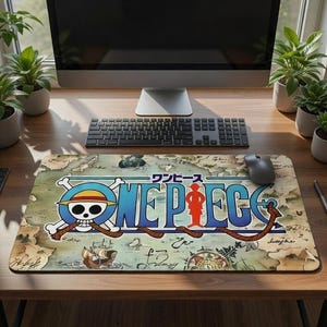 May include: A rectangular mousepad featuring the "One Piece" logo with a skull and crossbones, a straw hat, and the word "ONE PIECE" in blue. The design is set against a map background with Japanese text.