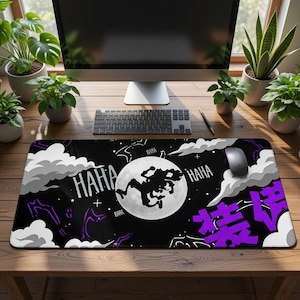 May include: Black mousepad with a cartoon graphic of a figure in front of a full moon, with "HAHA" and Japanese text in purple. White clouds and purple accents are on a black background. A computer mouse and keyboard are visible.