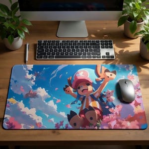 May include: A rectangular mousepad featuring a cartoon character with a pink hat and blue hair, set against a blue sky with fluffy clouds and pink flowers. A silver mouse and keyboard are visible.