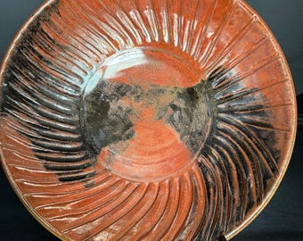 Handmade ceramic serving bowl with dramatic carved and glazed pattern