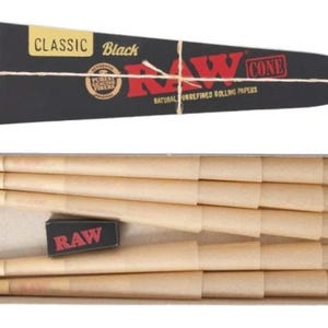 May include: A black triangular cardboard sleeve labeled CLASSIC Black RAW CONE with natural unrefined rolling papers text, positioned above a rectangular box containing several light brown paper cones and a small black box with red RAW text.
