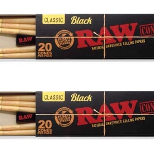 May include: Two rectangular black boxes of RAW Classic Black King Size cones. Each box features the red RAW logo, the text 20 CONES PER PACK, and a circular seal. The boxes are partially open, revealing light brown, pre-rolled paper cones inside.