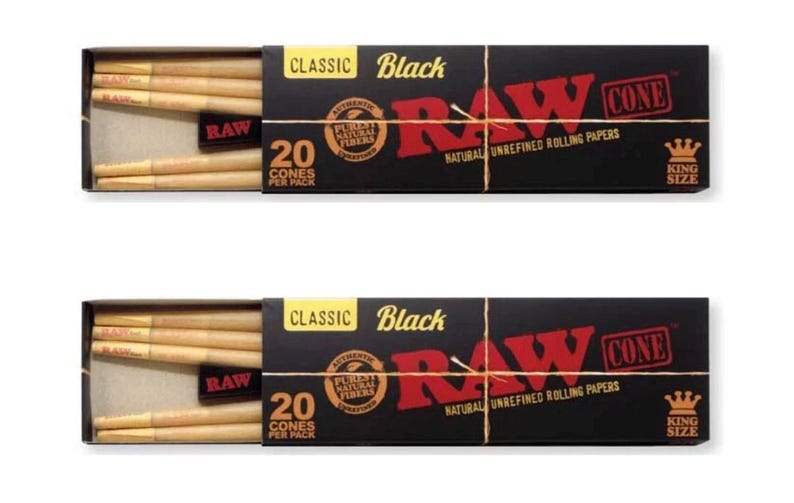 May include: Two rectangular black boxes of RAW Classic Black King Size cones. Each box features the red RAW logo, the text 20 CONES PER PACK, and a circular seal. The boxes are partially open, revealing light brown, pre-rolled paper cones inside.