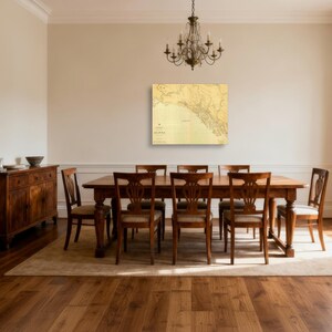 May include: A dining room with a large wooden table and eight chairs, a wooden sideboard, and a map of Alaska on the wall. A chandelier hangs above the table. The room has hardwood flooring and a neutral colour scheme.